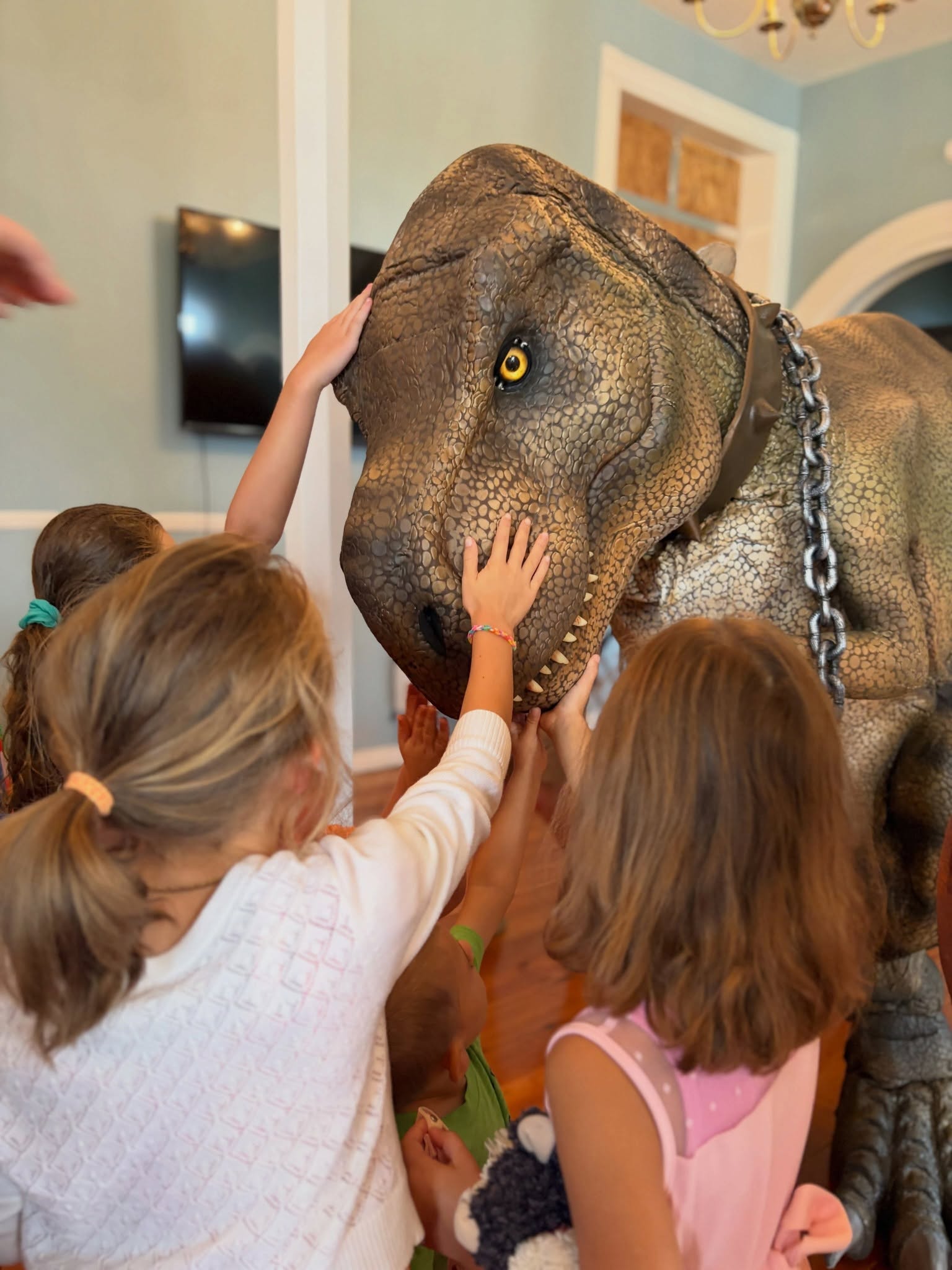 Kids petting a dinosaur